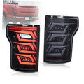 Smoked LED tail light set with red illuminated bars and clear lenses, black housing