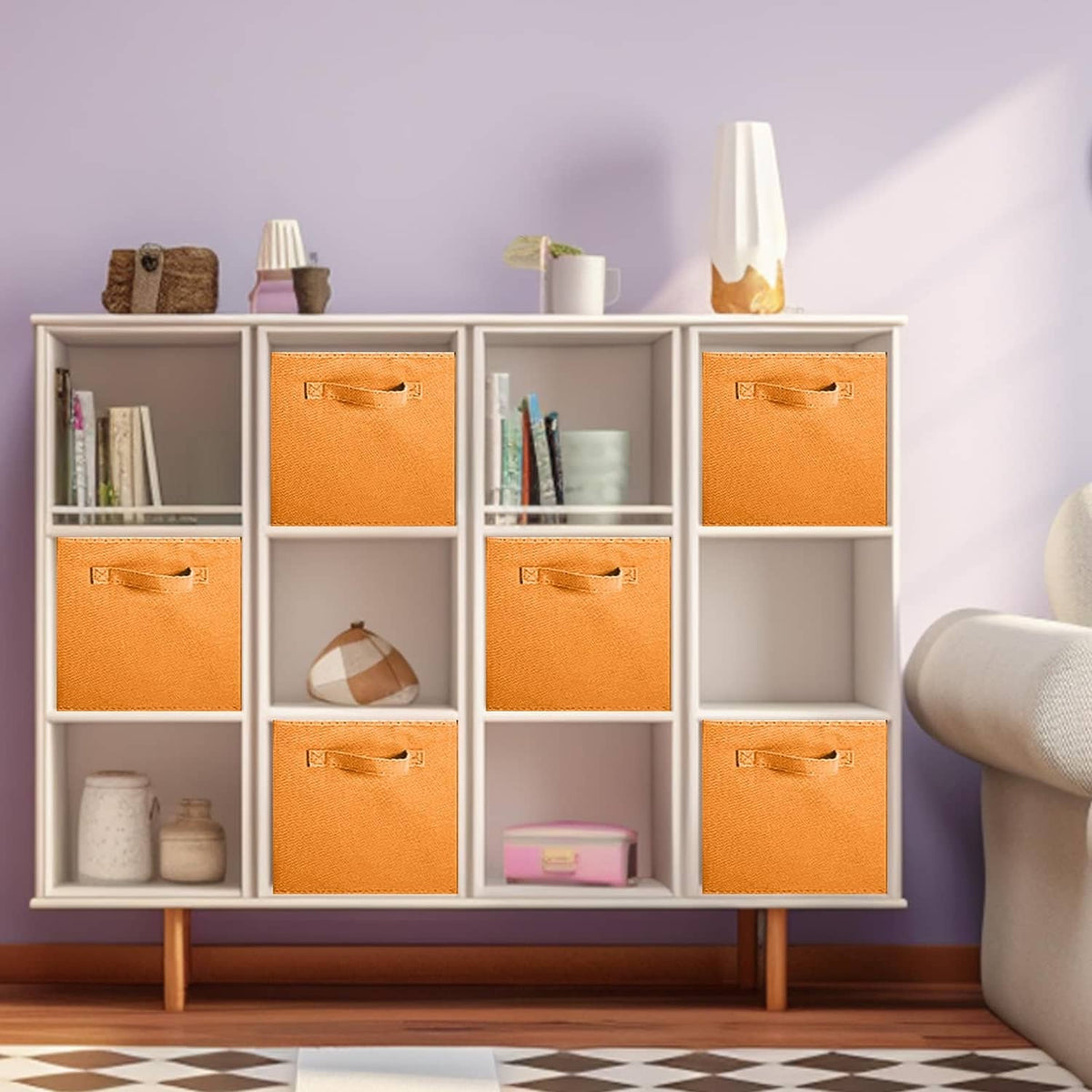 Set of orange fabric storage cubes in a white cubby shelf, top handles visible