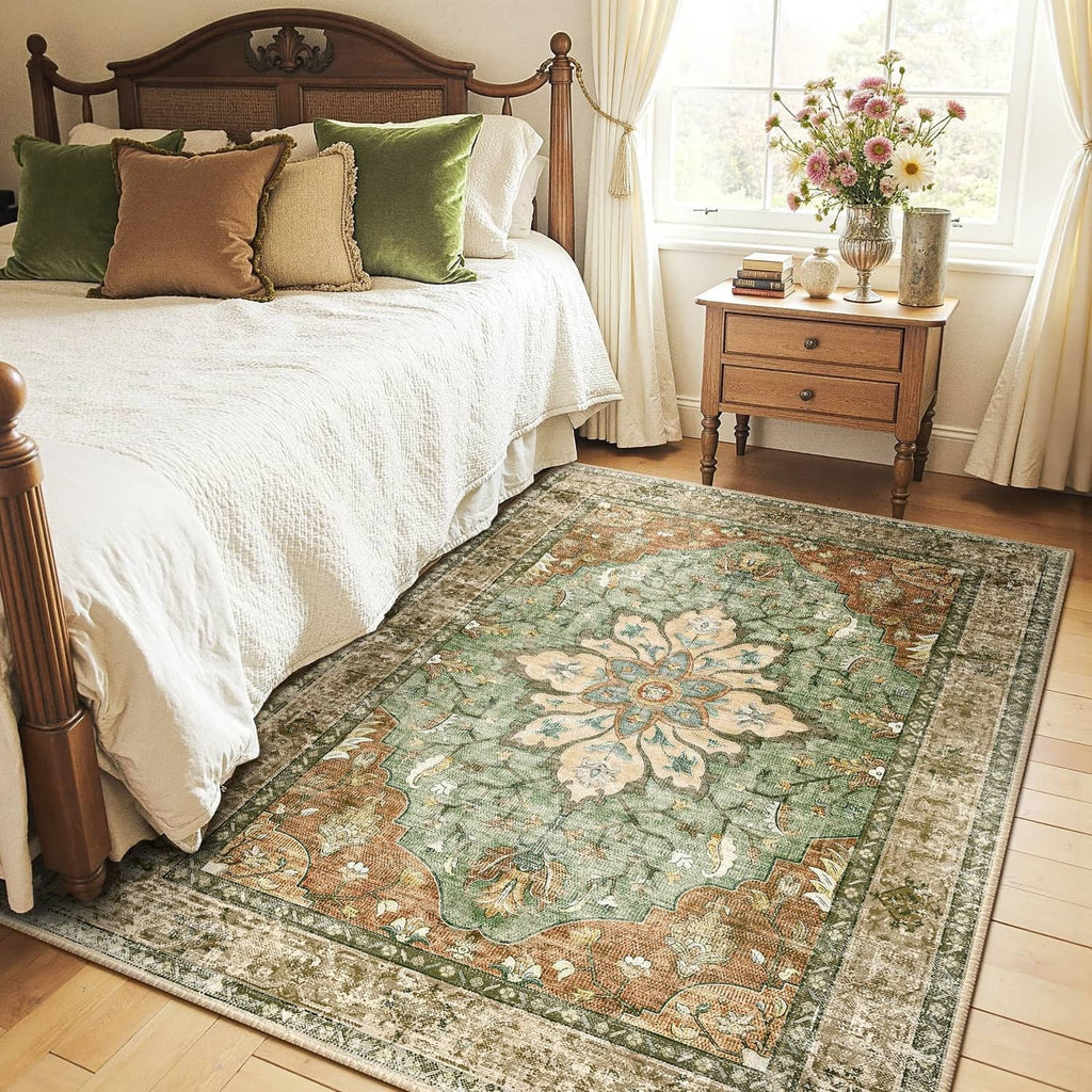 Rectangular floral area rug with green, brown, and brick tones and dark border trim.