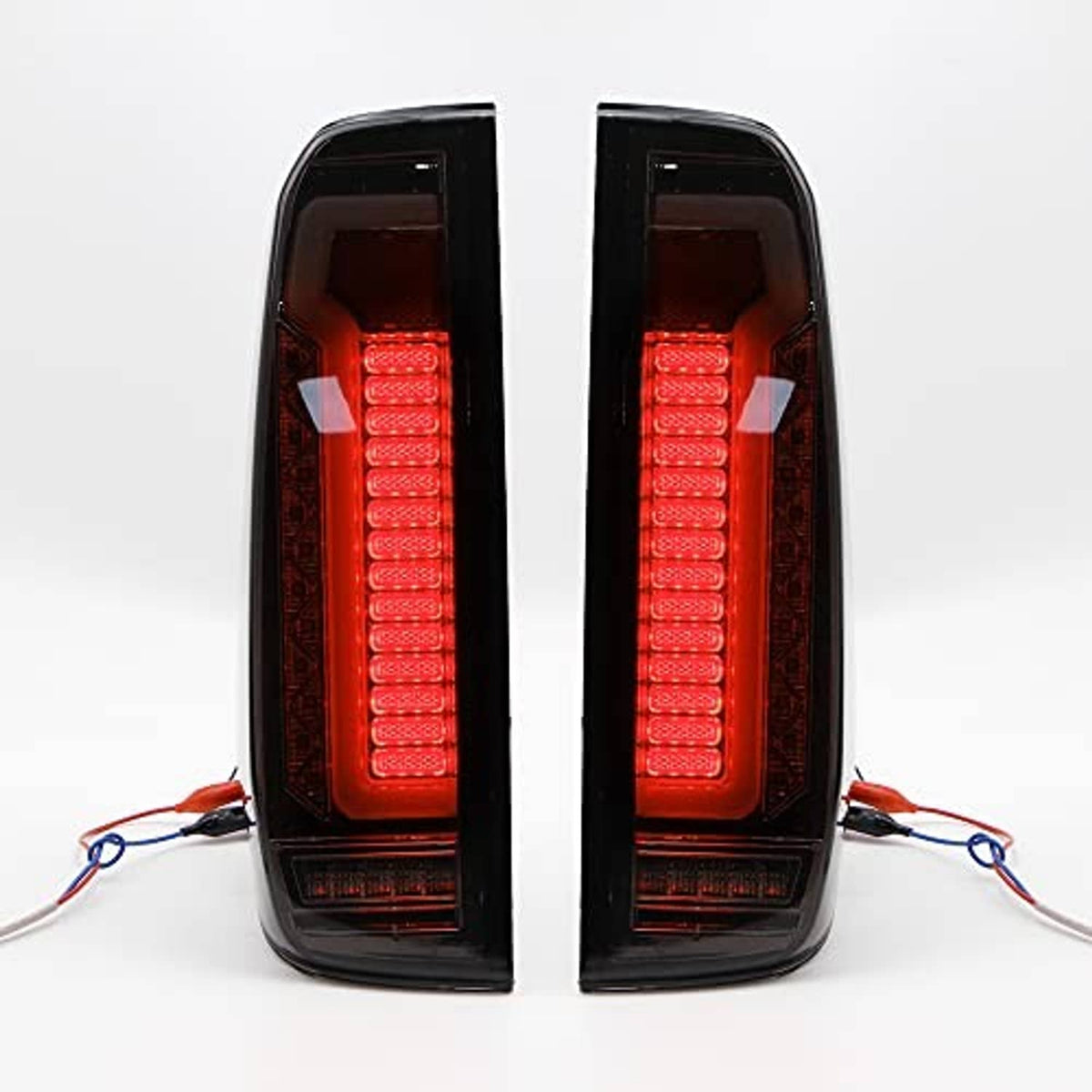 Pair of LED tail lights with red illuminated inner bars behind tinted outer lens, black housings