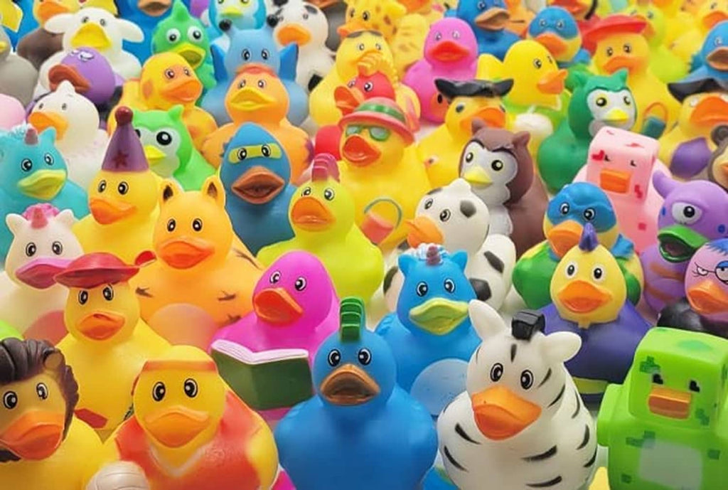 Assorted rubber duck toy assortment in mixed bright colors, many small bath ducks