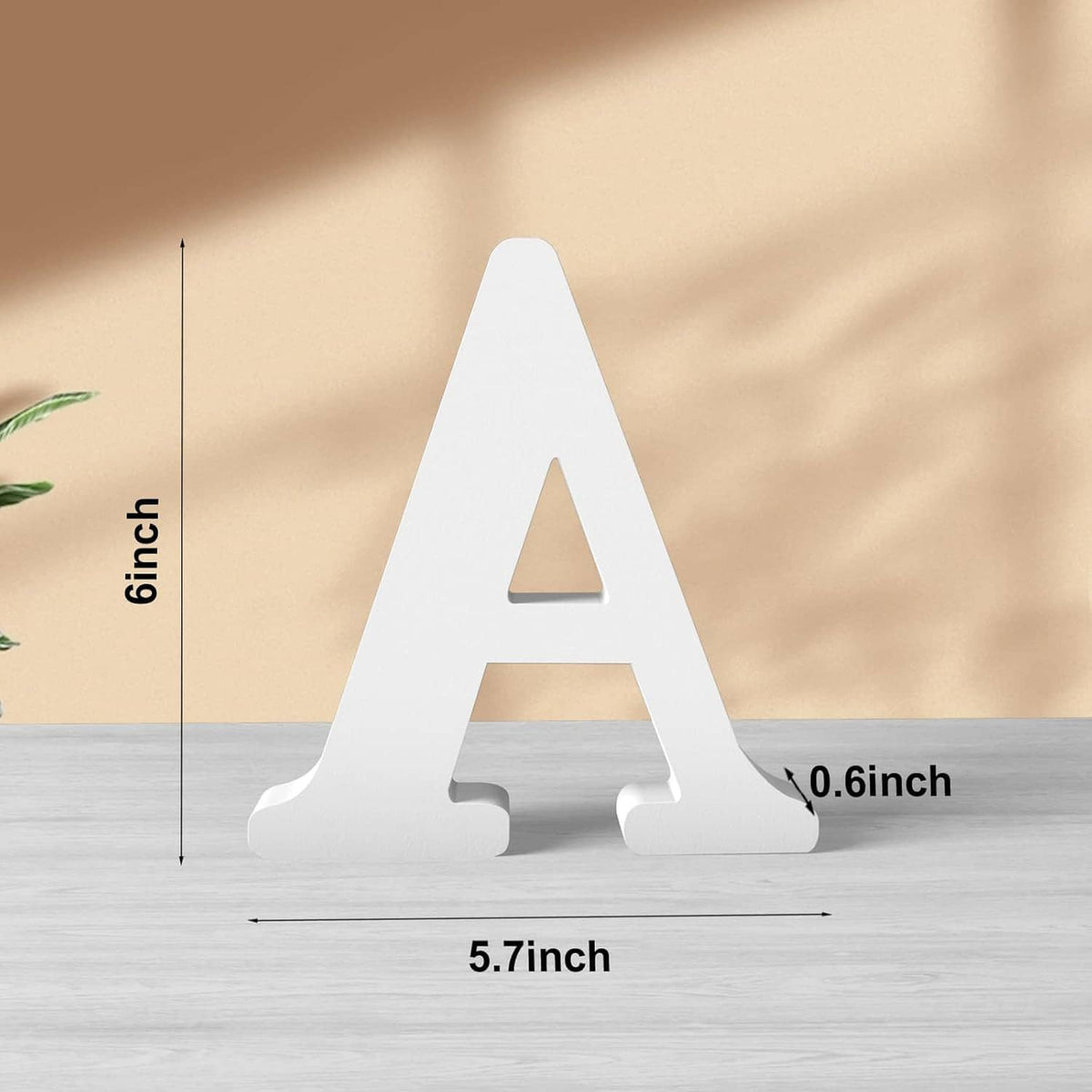 White wooden letter A with cutout center, freestanding on base