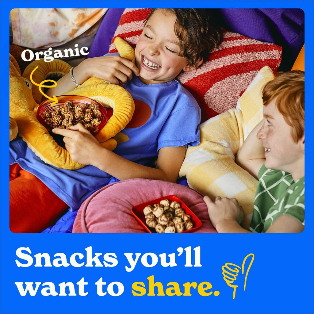 Family sharing chocolate chip granola minis snacks in a bed setting