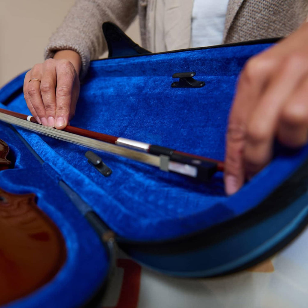 Black ABS bow holder attached inside violin case near bow compartment