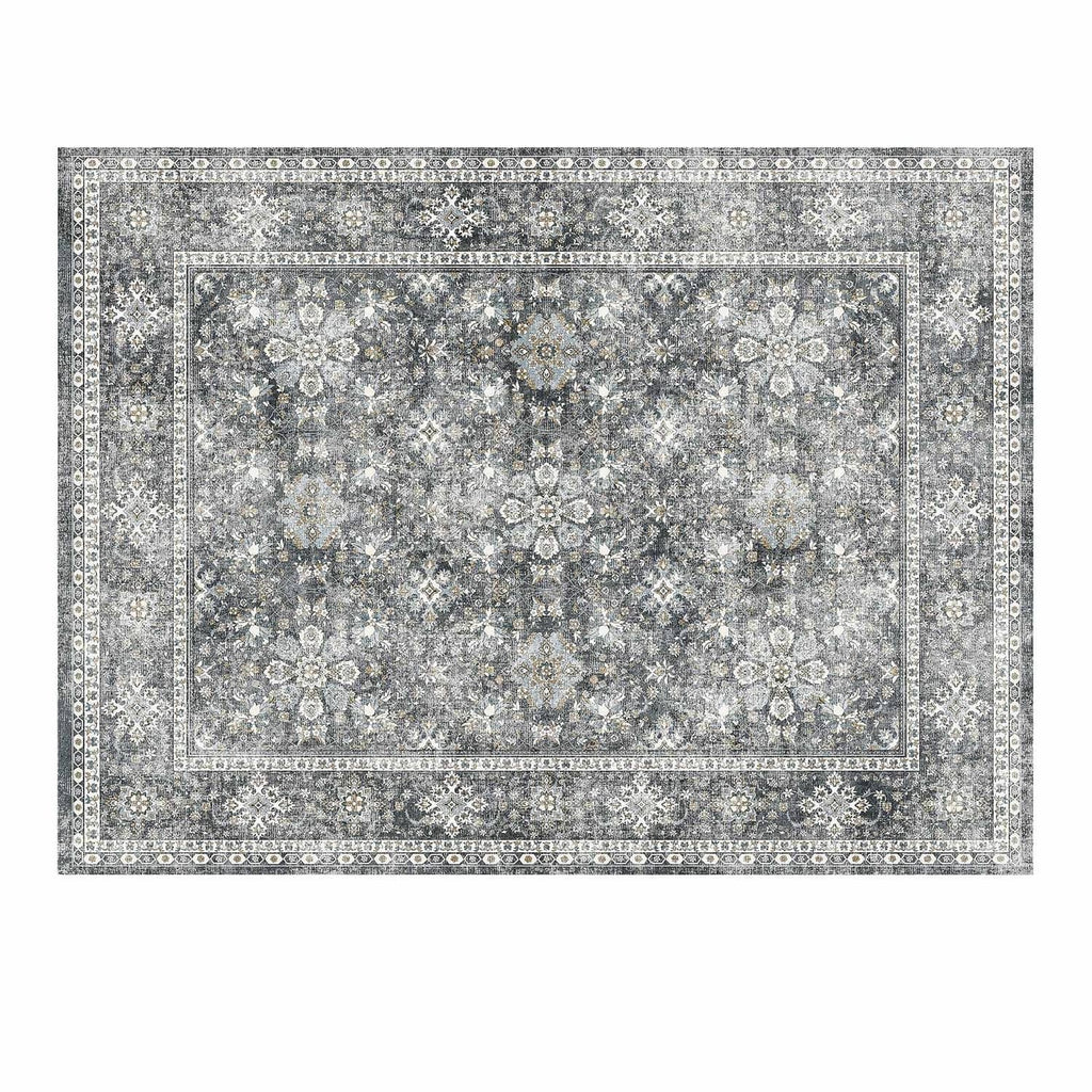 Gray vintage area rug close-up with intricate floral medallion pattern and border