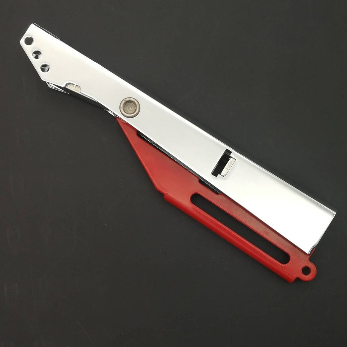 Silver metal striker head and red handle with oval end loop