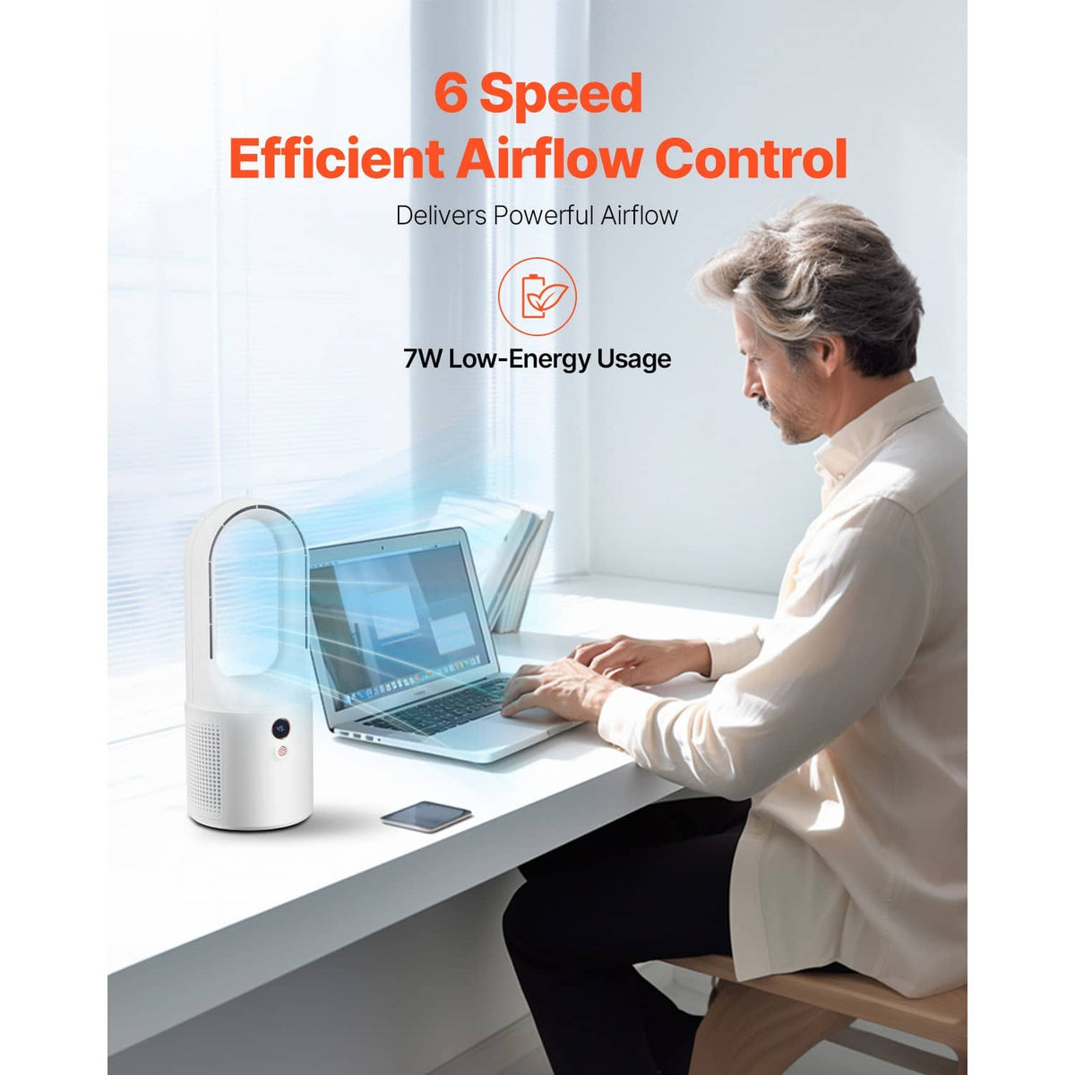 White bladeless desktop fan with compact base, shown on a desk near a laptop.