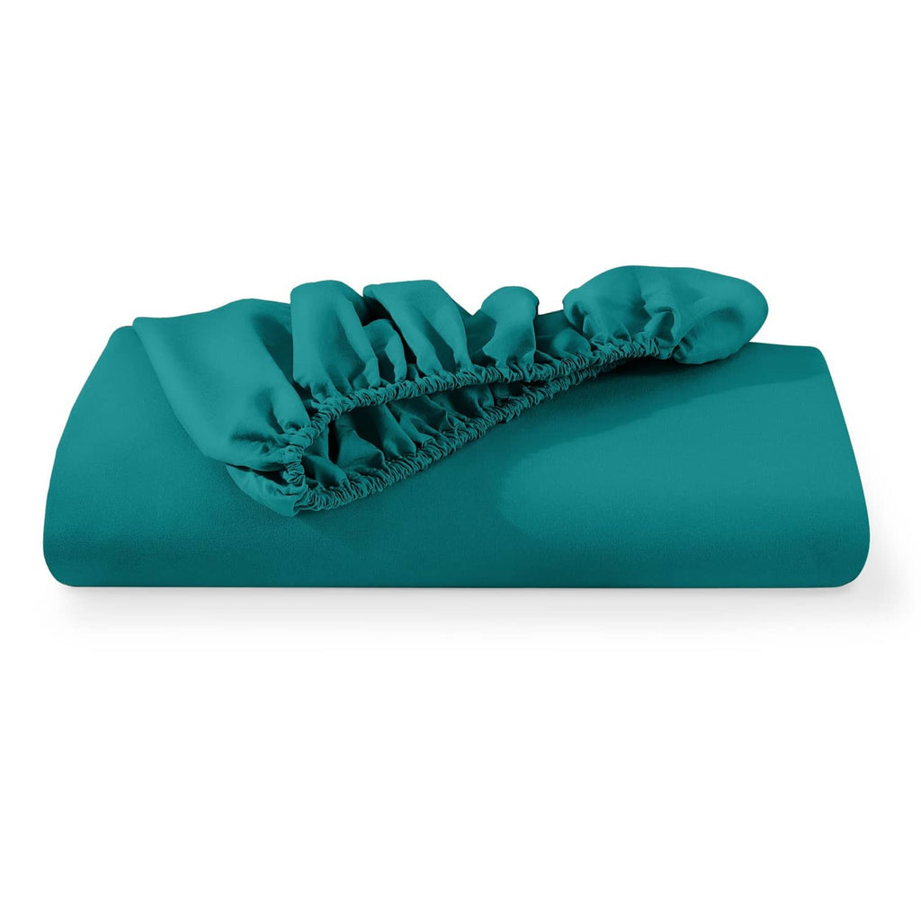 Teal green twin fitted sheet folded with elastic hem visible