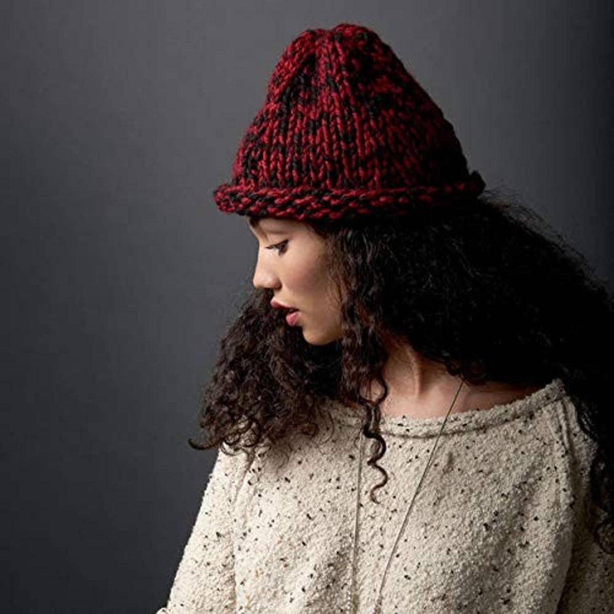 Dark red and black knit beanie with ribbed brim and textured crown