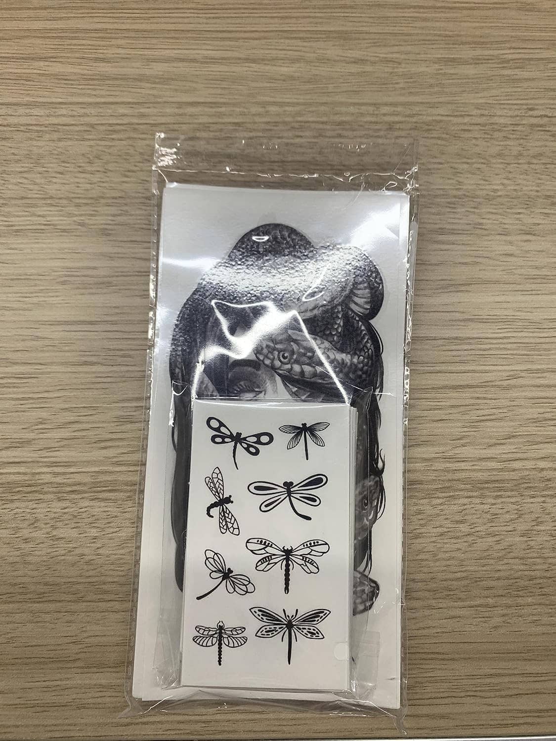 Sealed temporary tattoo sheet pack featuring black cat and dragonfly artwork