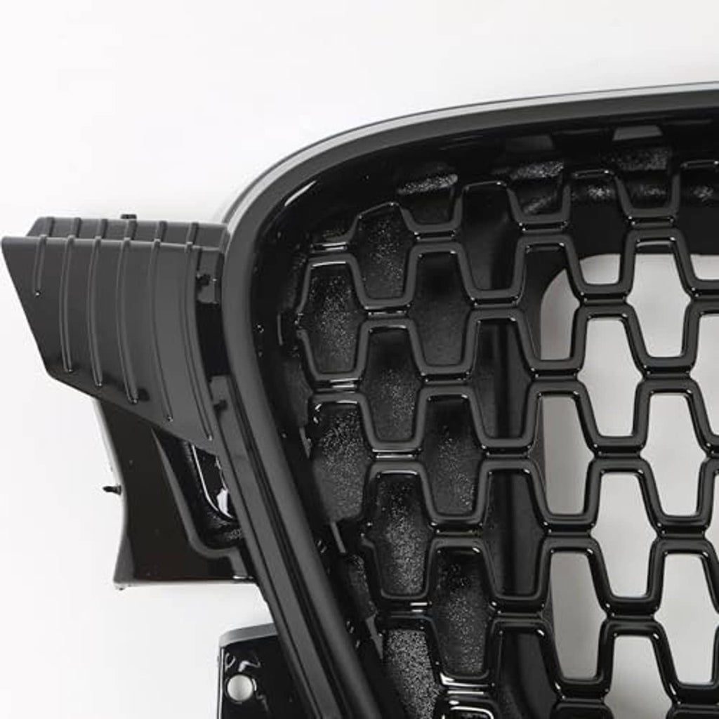 Close-up of black grille mounting housing with textured edge and honeycomb mesh