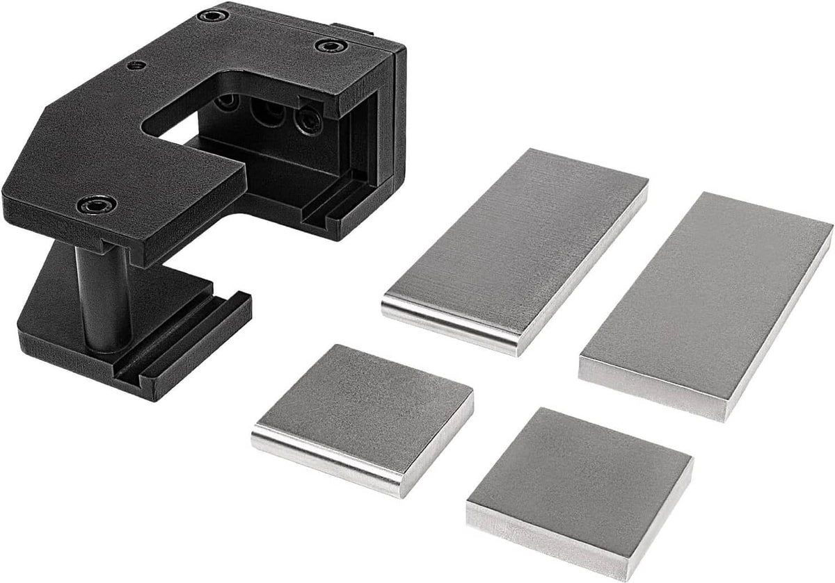 Black guillotine forging tool set with flat die plates, shown with four extra dies
