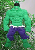 Green Hulk-style shatterproof Christmas ornament, hanging front view with purple shorts.