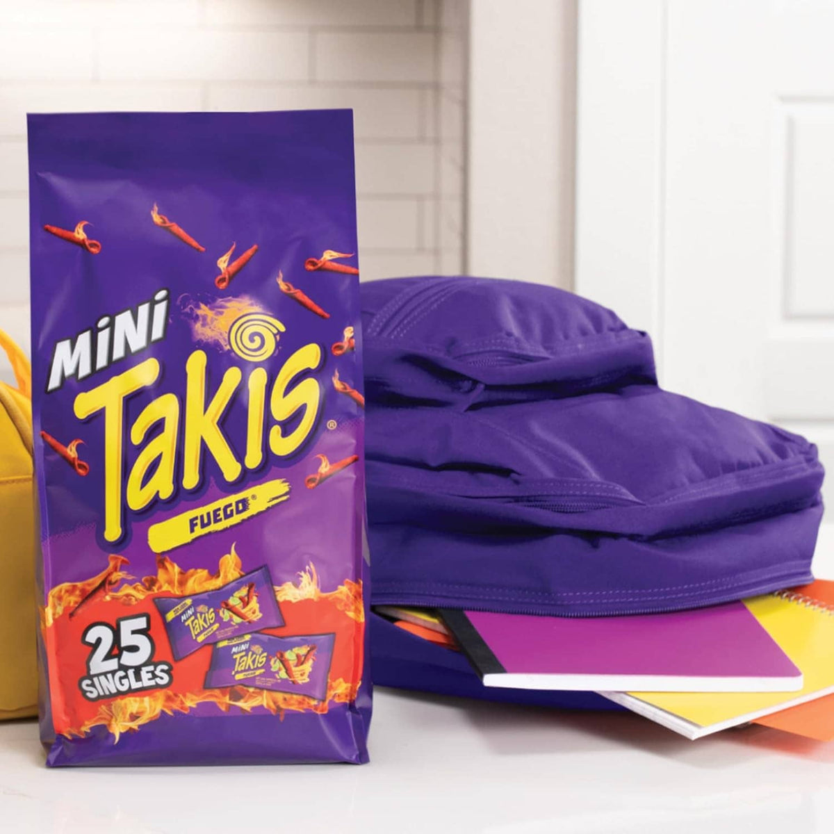 Takis Mini Fuego snack pouch next to purple slip-on shoes
