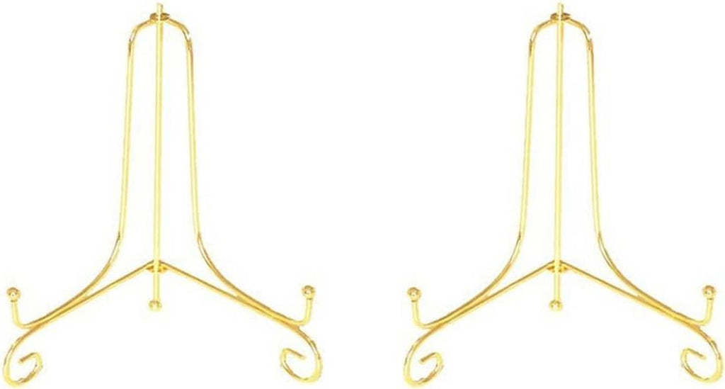 Pair of gold metal plate stands with arched frame and three curled feet.