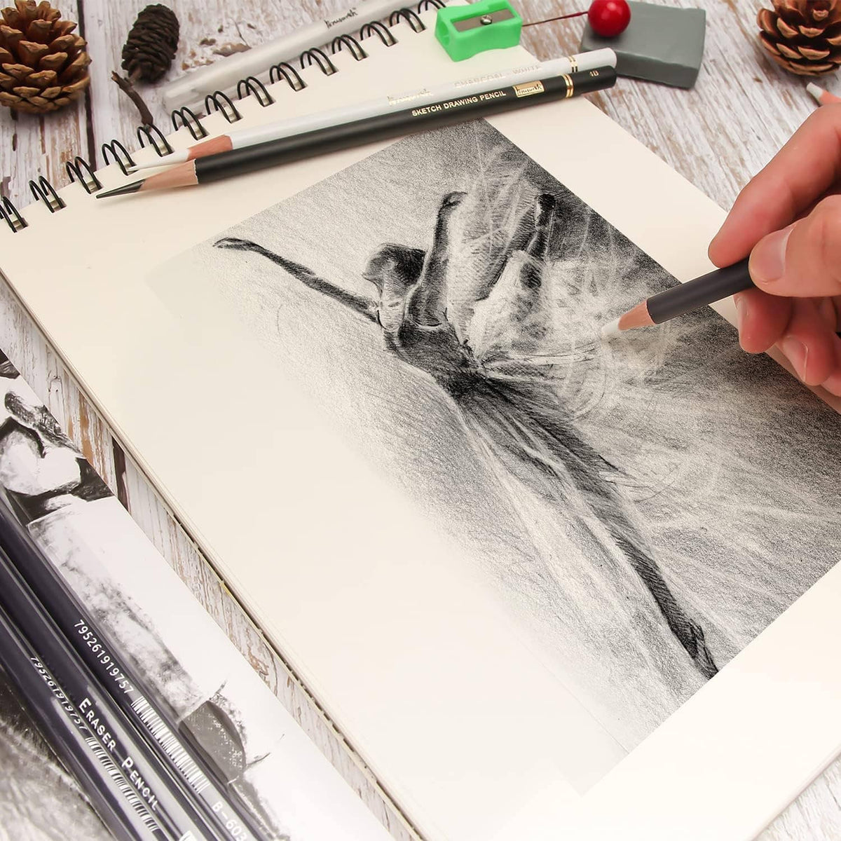 Eraser pencil erasing charcoal sketch on paper with a dark navy pencil tip