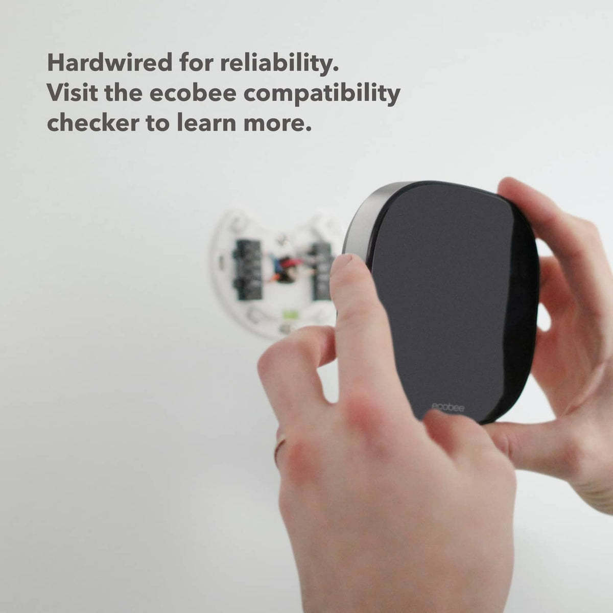 Black smart security keypad device with hands holding for mounting