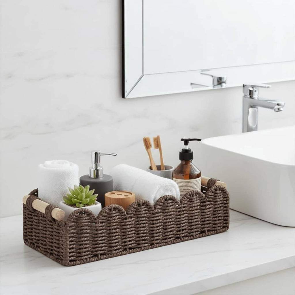 Brown woven toilet paper storage basket with scalloped sides on a bathroom counter