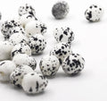 Artificial quail eggs pile, white shells with black speckles, decorative faux set