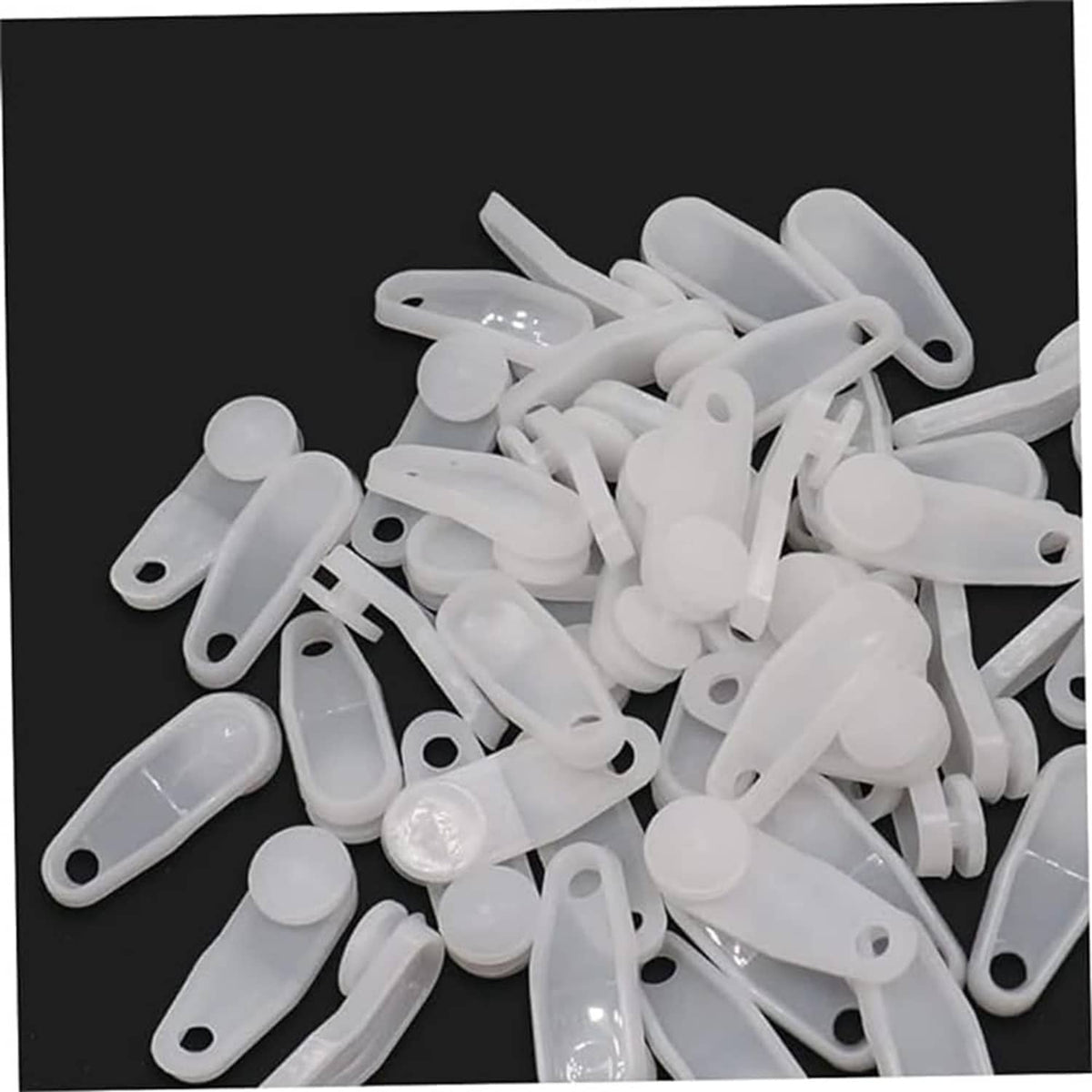 Pile of white plastic snap-in curtain traverse rod slides