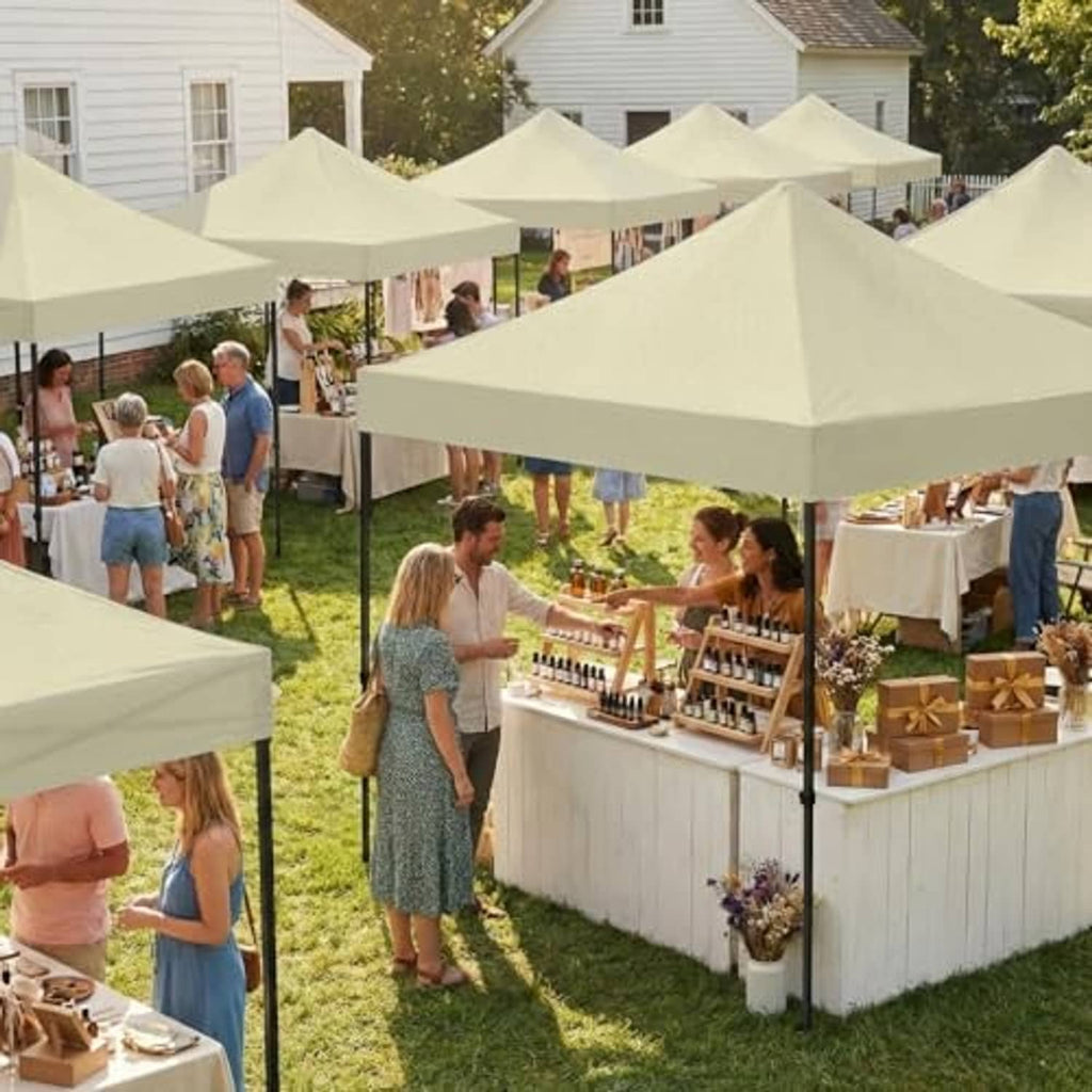 Beige canopy tops at outdoor market with peaked roofs and support poles