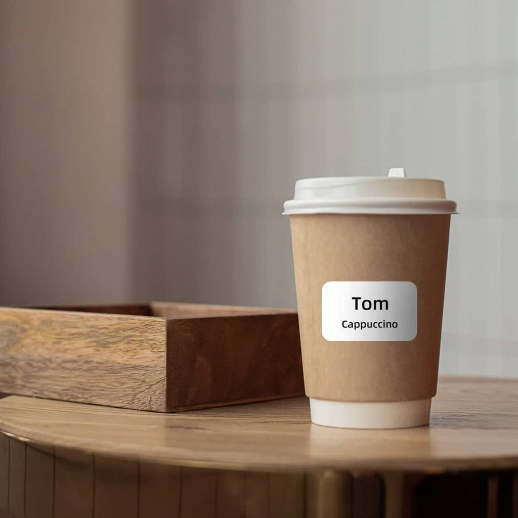 Coffee cup label sticker reading Cappuccino on a disposable drink cup