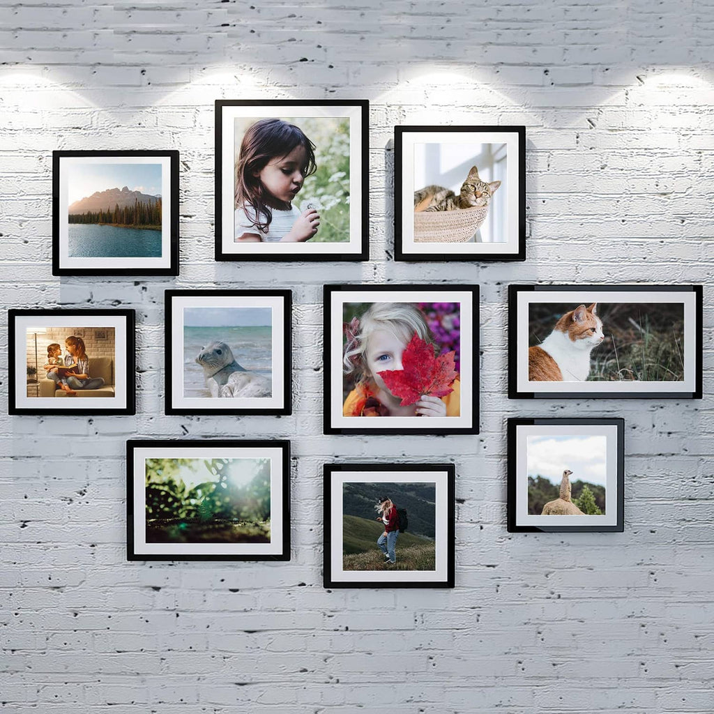 Black picture frame set arranged in a gallery grid with mixed photos