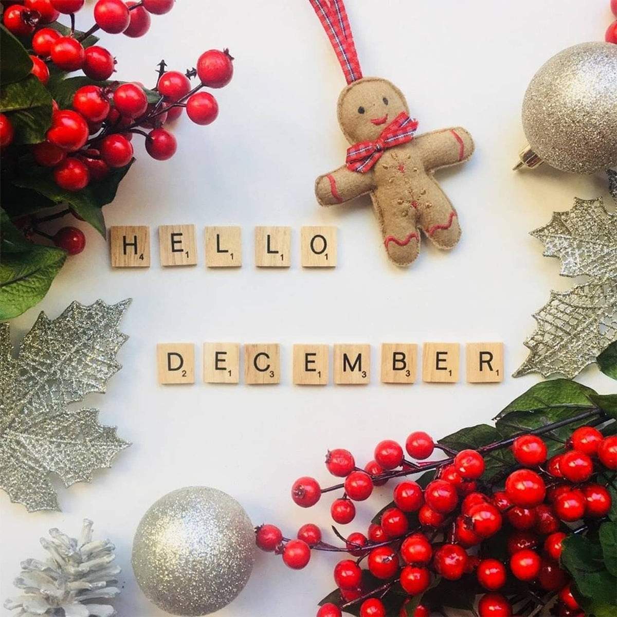 Wood letter tiles spelling “HELLO” and “DECEMBER”, with decorative holiday ornaments