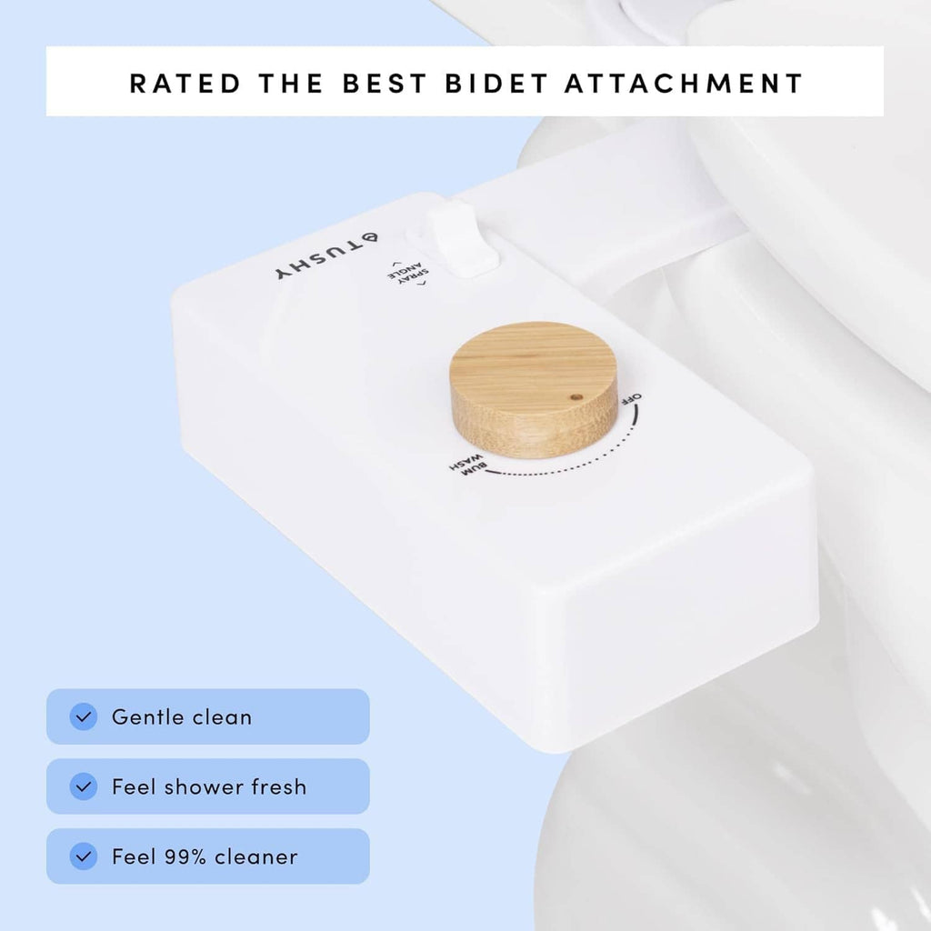 White bidet attachment with circular knob shown on toilet seat and rim