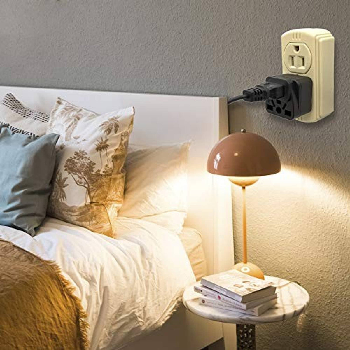 Black travel plug adapter inserted into US wall outlet with three openings