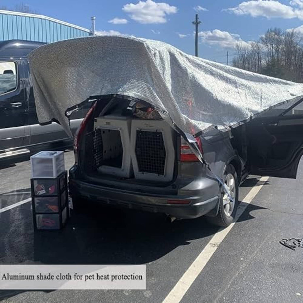 Reflective silver shade cloth draped over an RV rear cargo area for sun protection