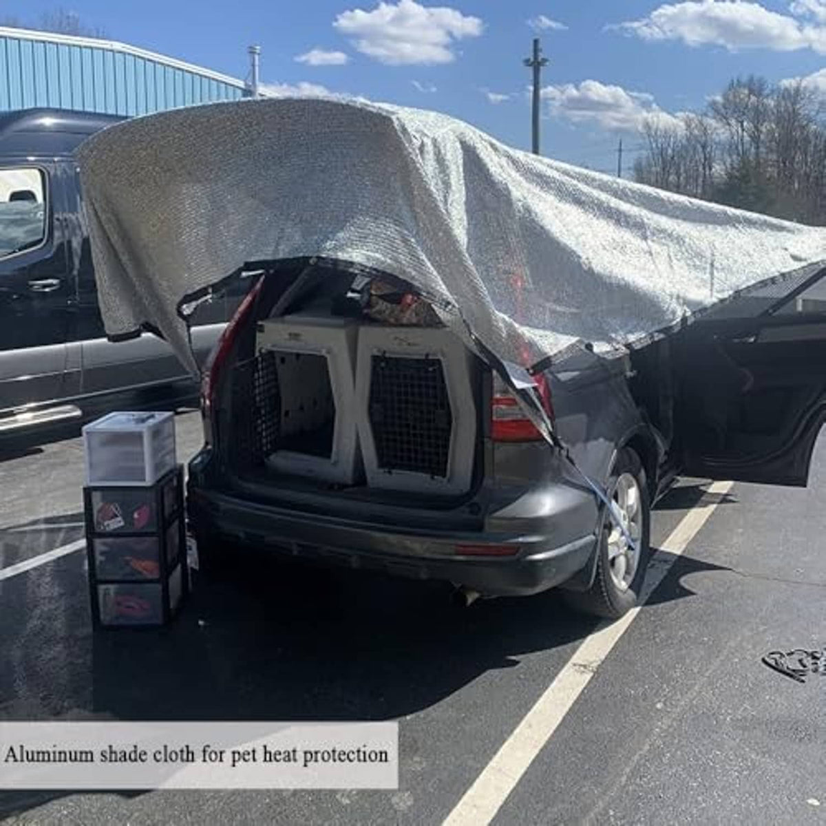 Reflective silver shade cloth draped over an RV rear cargo area for sun protection