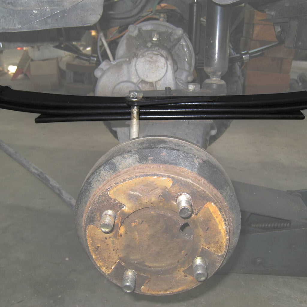 Installed rear leaf springs and bushings on golf cart axle area with mounting hardware