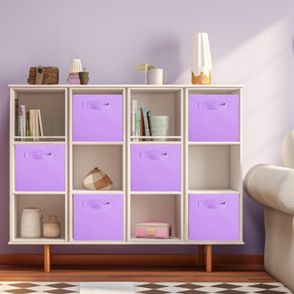Lavender foldable fabric cube bins with top pull handles inside a shelf cabinet