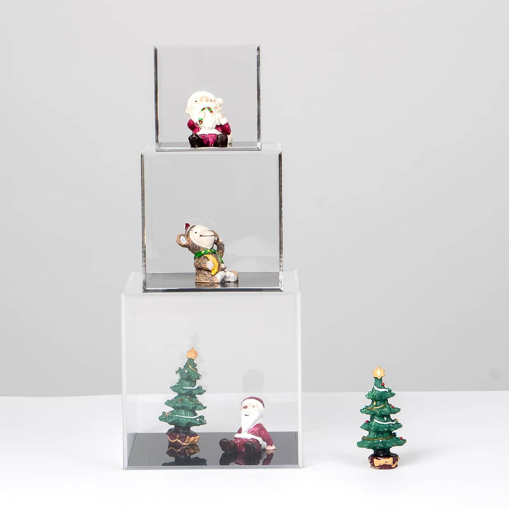 Stacked clear acrylic display cubes with small figurines on shelves