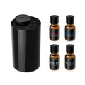 Black waterless essential oil diffuser with four amber aroma oil bottles