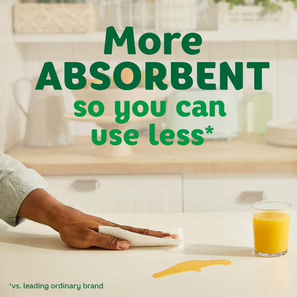 Paper towel roll being used to wipe a spill on a countertop
