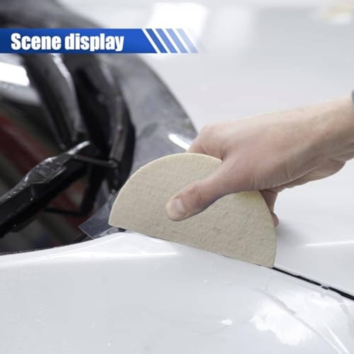 Soft wool felt squeegee pad applying vinyl on a car window surface