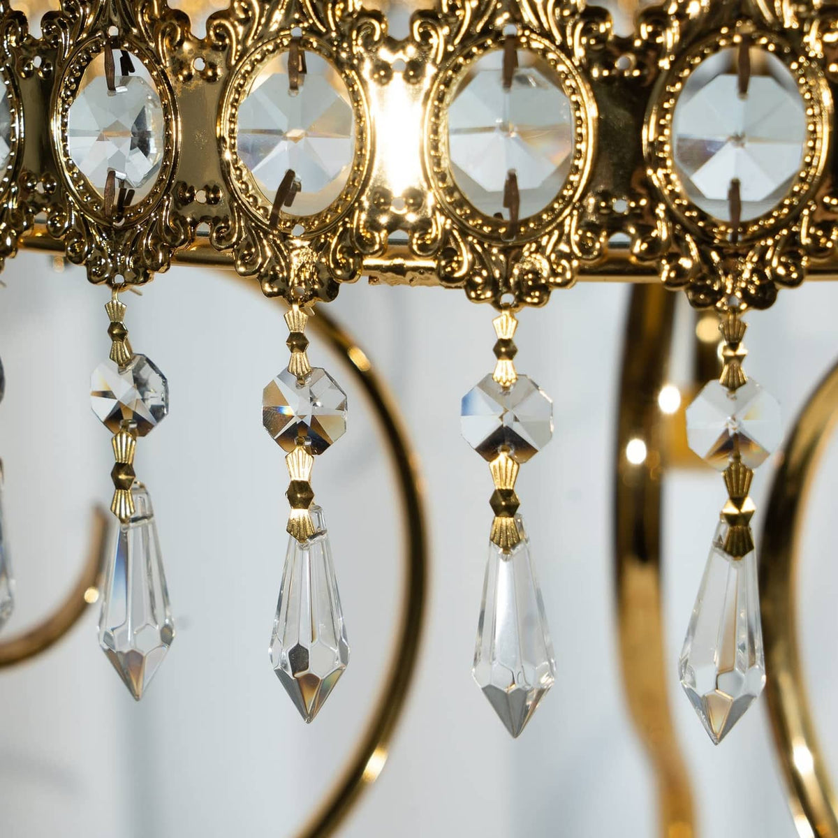 Gold-framed crystal connector drops with clear faceted prisms and caps