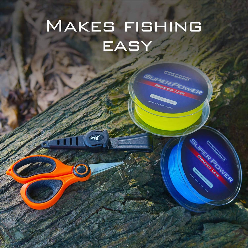 Orange-and-black fishing line scissors with included fishing line spools on rock surface