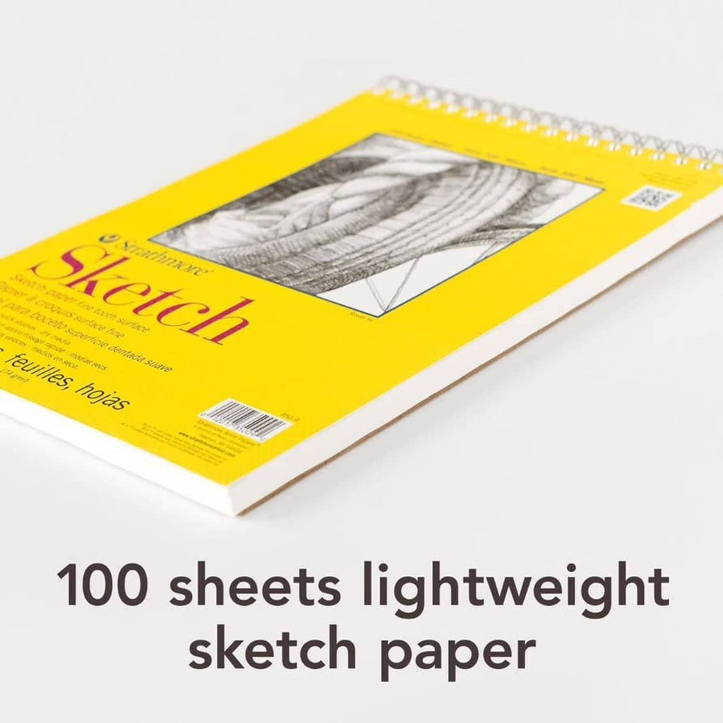 Close-up of yellow spiral sketch pad cover corner with printed artwork window