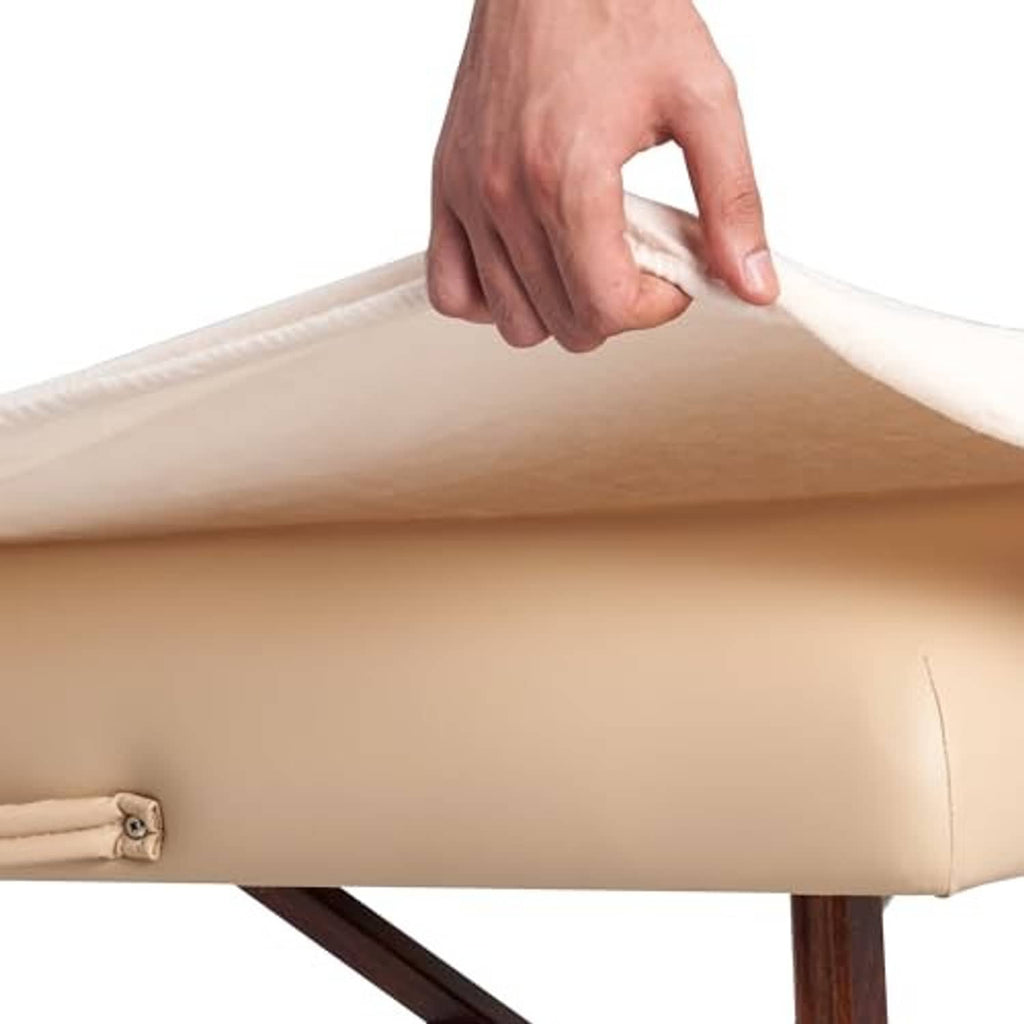 Light beige flannel sheet corner close-up with strap loop and elastic detail.