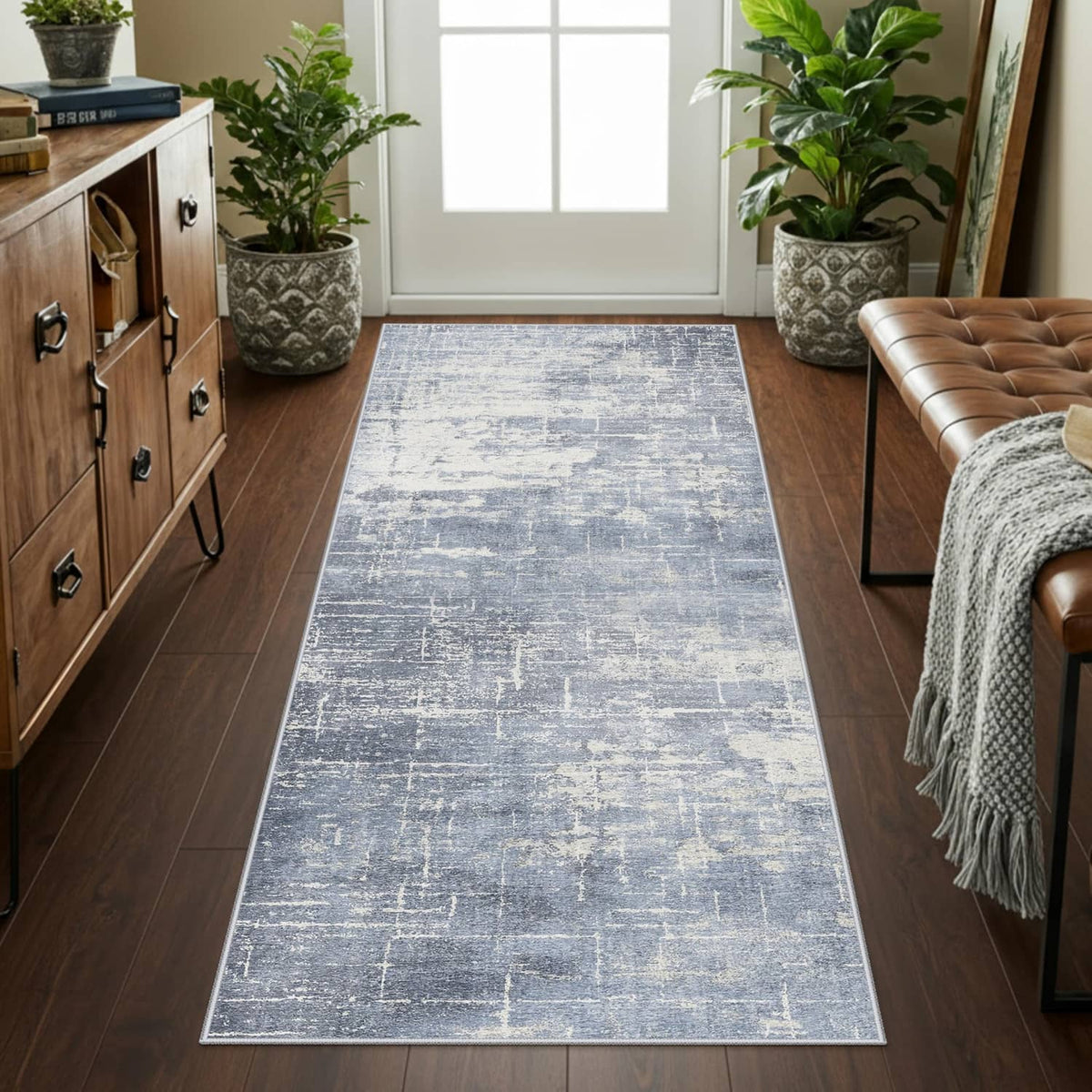 Blue and ivory long rectangular runner rug placed in a living room walkway.