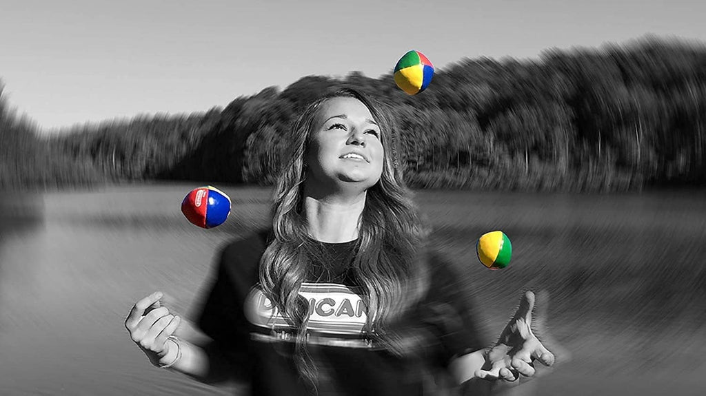 Multicolor vinyl juggling balls in the air, including red, blue, green, and yellow.