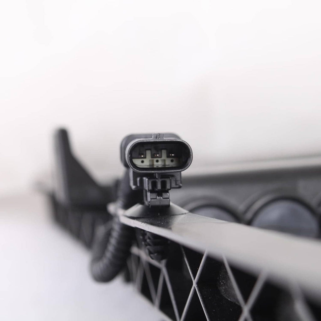 Actuator motor electrical connector close-up on grille shutter assembly