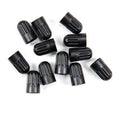 Black plastic long tire valve stem caps, multiple caps shown