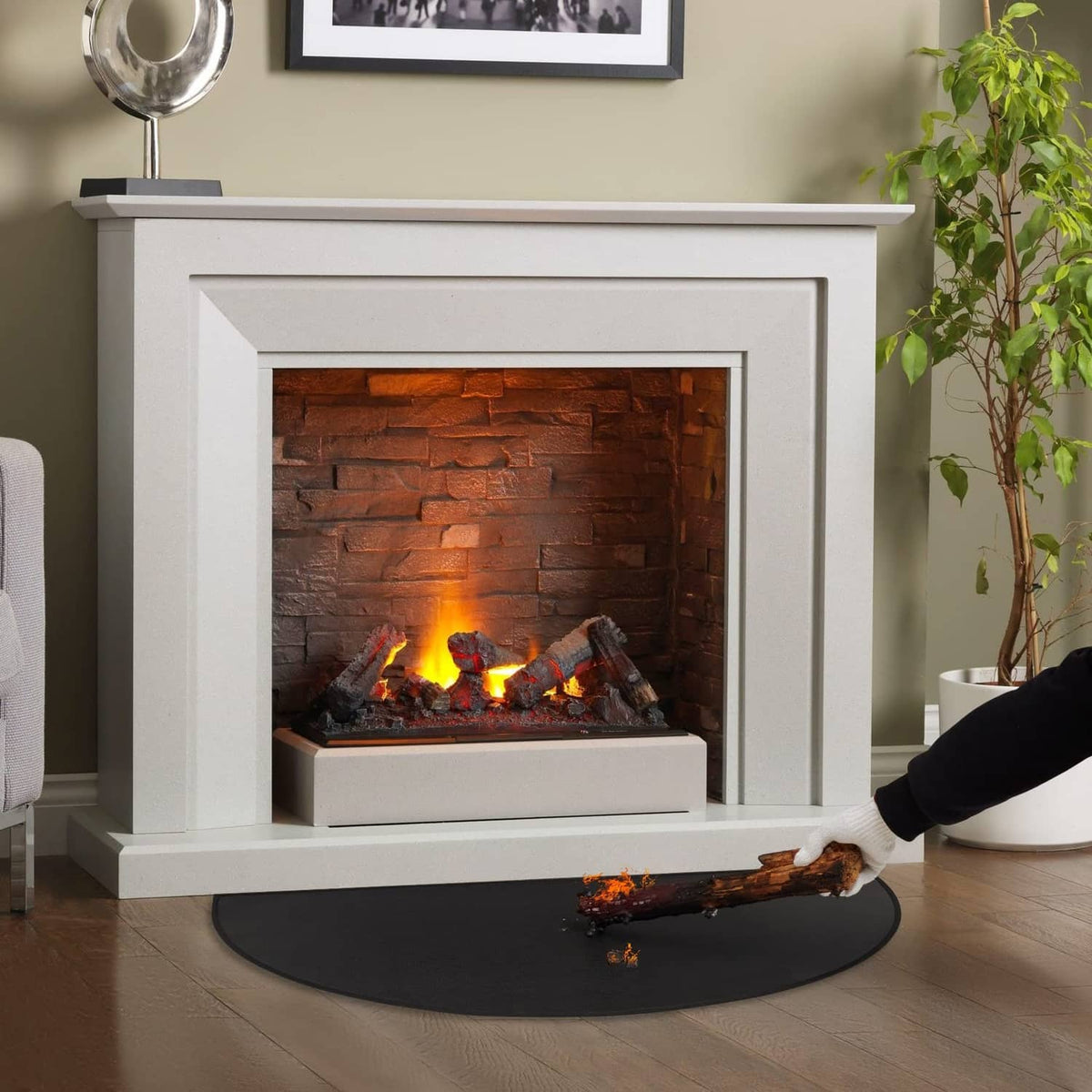Black half-round fireplace hearth mat under a roaring indoor fire
