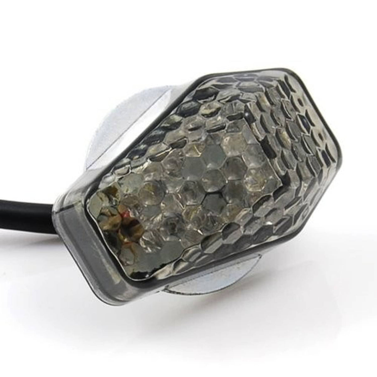 Smoke-lens LED turn signal indicator with clear reflector and black mounting wire, close-up