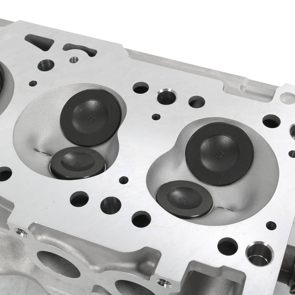 Cylinder head close-up of combustion chambers and machined holes, metallic silver