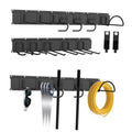 Black wall-mounted tool organizer rail with multiple hanging hooks and storage slots
